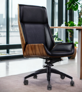 Alto wood veneered leather executive office chair in black, featuring a high backrest and rolling base in an office.