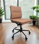 Brown office chair on a wooden floor with plants in the background