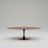 Modern wooden dining table with black base in a minimalistic room.