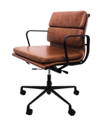 low back office chair in tan leather with black swivel base on white background.