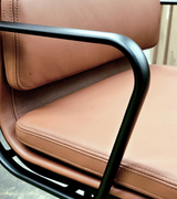 Brown leather chair with black metal frame