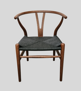 A midcentury style dining chair with a light walnut stain finish on ash wood, featuring a Y-shaped backrest and a natural cord seat.