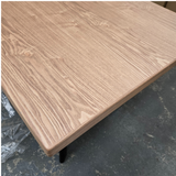 Wooden table top on a dark surface