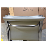 Metallic chair with 'Onske' branding in the background