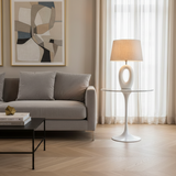 A round white marble tulip side table with a white cast aluminium base.