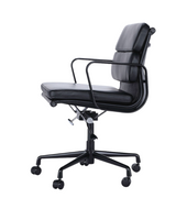 Side view of low back office chair in black premium leather with black swivel base on white background