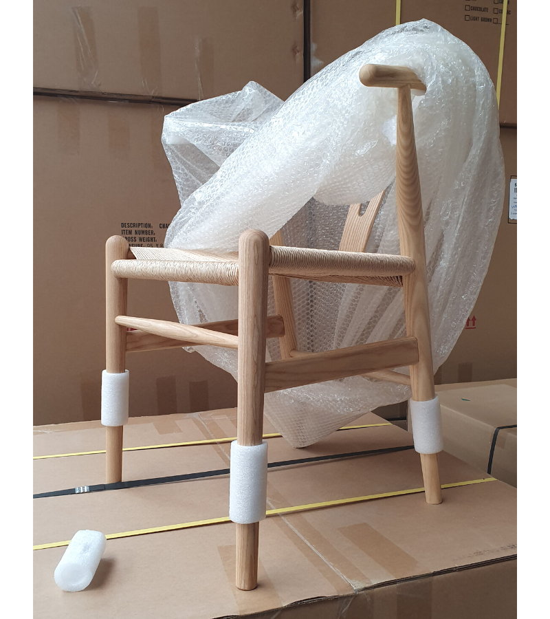 Natural ash wishbone chair in warehouse
